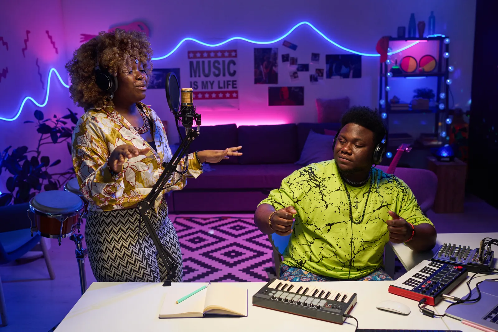Home recording studio equipment including audio interface, studio monitors, and MIDI controller on a desk