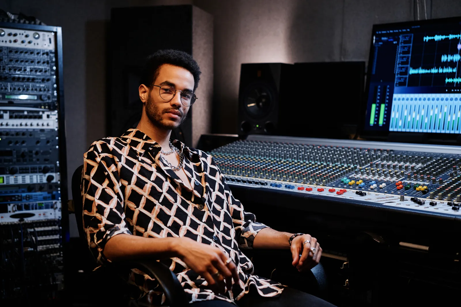 professional mixing console for studio with faders and EQ controls in a recording environment