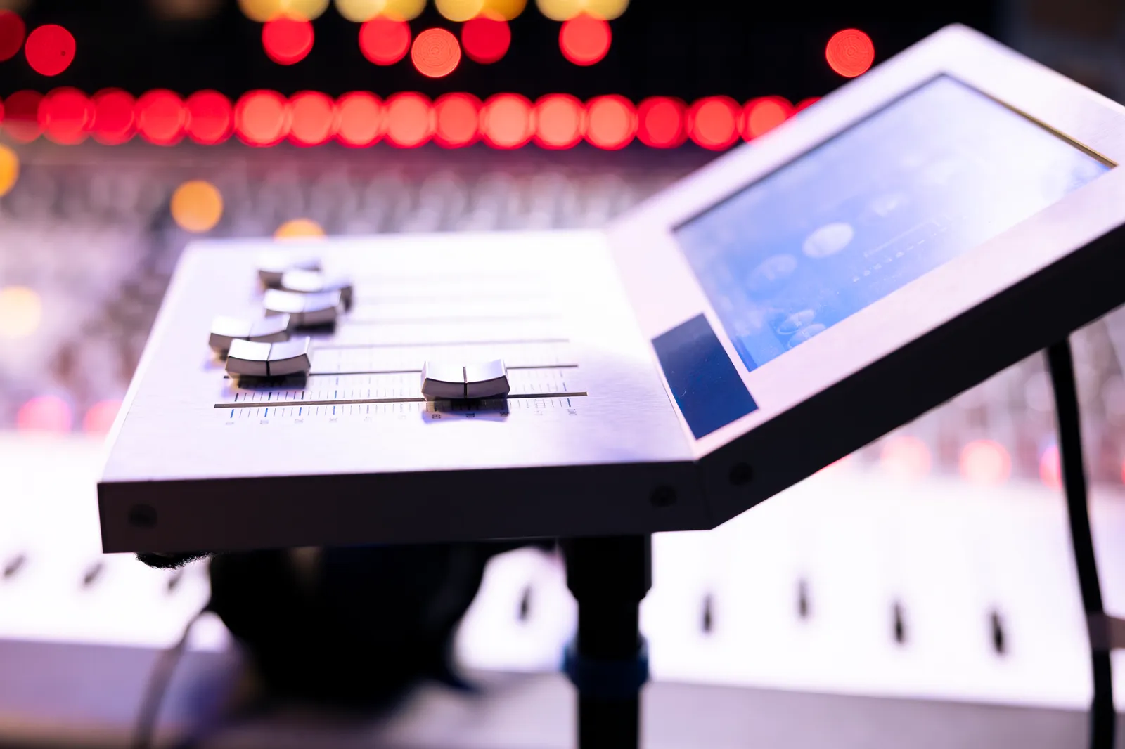 Close-up of motorized faders on a professional mixing controller