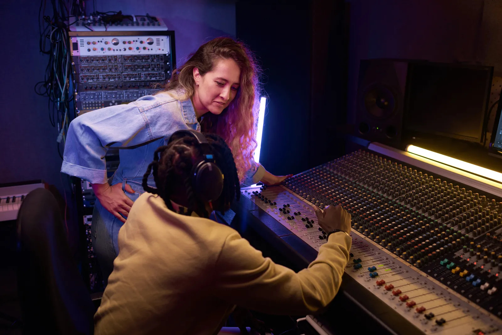 SSL UF8 DAW controller with motorized faders on a studio desk
